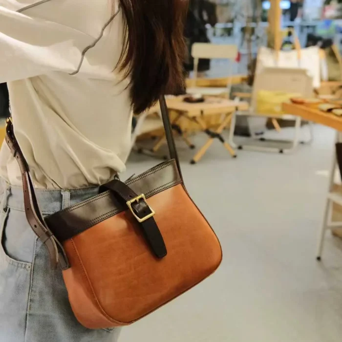 Woman carrying Handmade Leather Crossbody Bag while walking in city