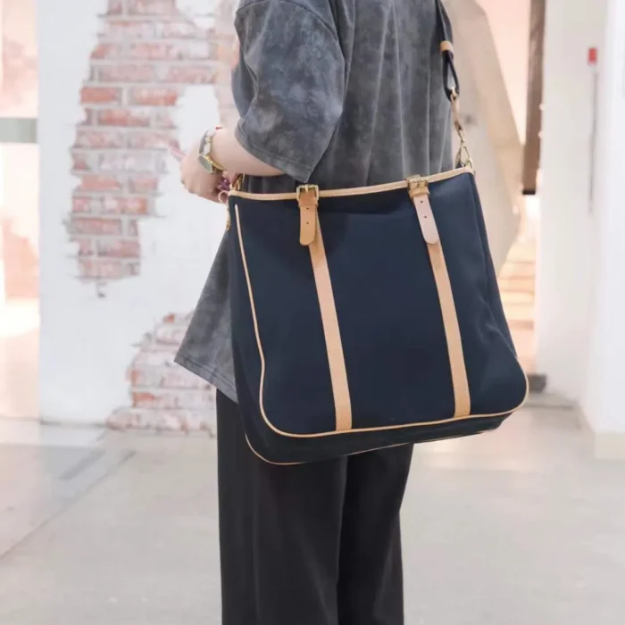 Urban lifestyle shot with Original Canvas & Leather Tote Bag – Carrying books, tablet, and daily essentials