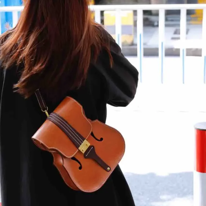 Designer and violinist wearing her own handcrafted honey-brown leather backpack, blending music and craft