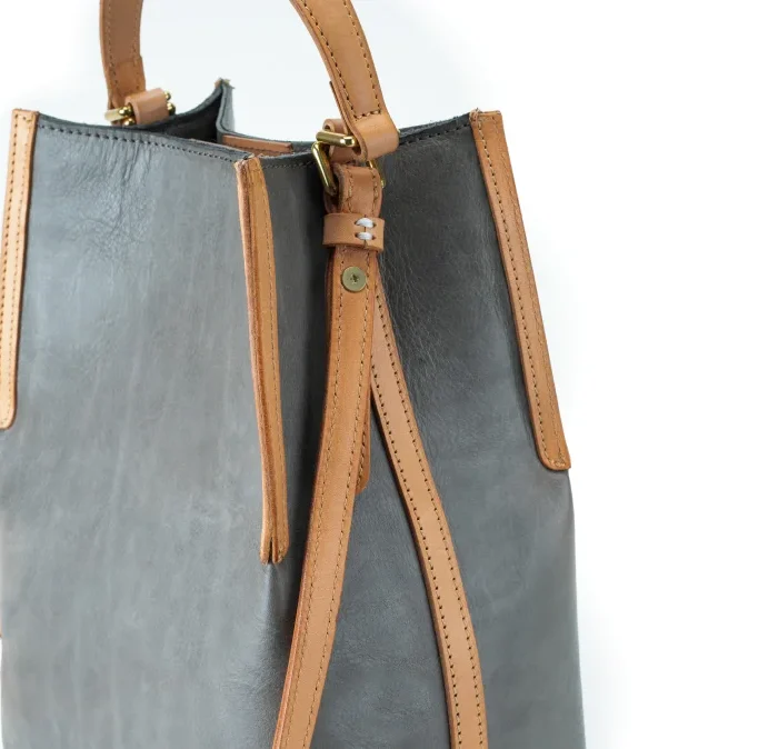Handcrafted vegetable-tanned leather contrast bag with fine stitching and contrast leather accents