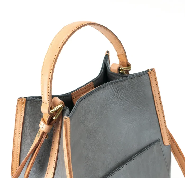 Close-up of artisanal leather texture on handcrafted vegetable-tanned leather contrast bag