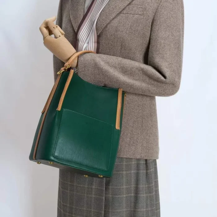 odel carrying handcrafted vegetable-tanned leather contrast bag as a shoulder bag