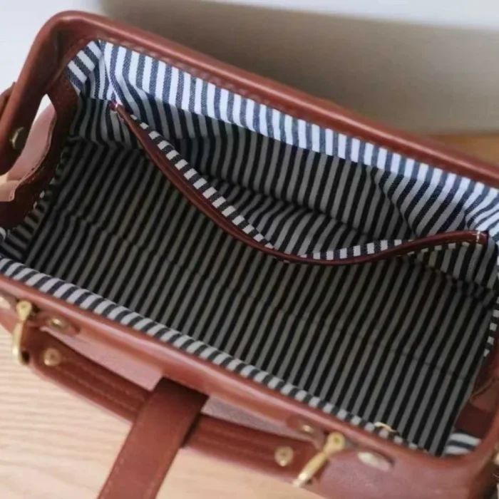 Interior of handcrafted vegetable-tanned leather doctor bag with zipper pocket