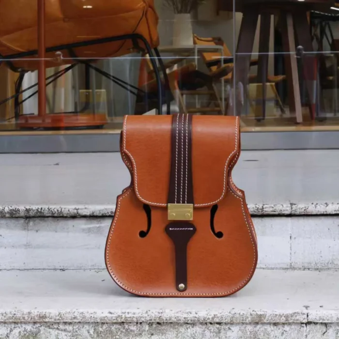 Back view of handmade violin-inspired leather backpack with adjustable straps