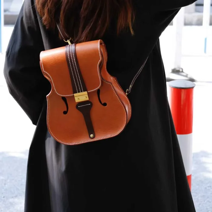 Designer and violinist wearing her own handcrafted honey-brown leather backpack, blending music and craft