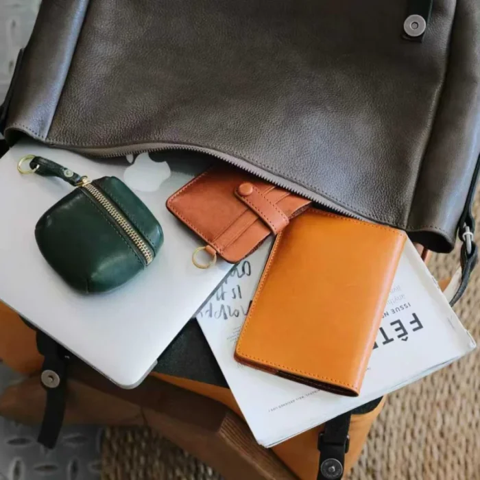 vegetable-tanned leather shoulder bag holding essentials, demonstrating roomy interior for everyday use