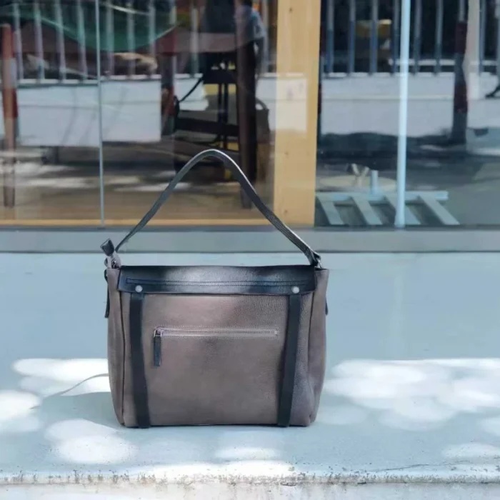 ack view of vegetable-tanned leather shoulder bag showing clean minimalist design
