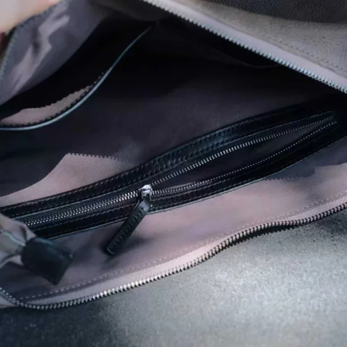 interior slip pocket of vegetable-tanned leather shoulder bag for organized storage