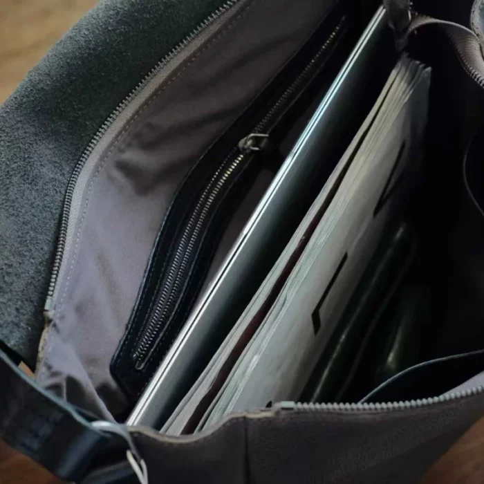 interior slip pocket of vegetable-tanned leather shoulder bag for organized storage
