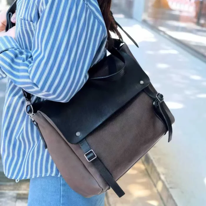model wearing vegetable-tanned leather shoulder bag crossbody in morandi gray