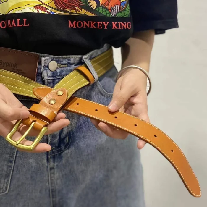 female model pairing white canvas leather belt with denim for a clean summer look