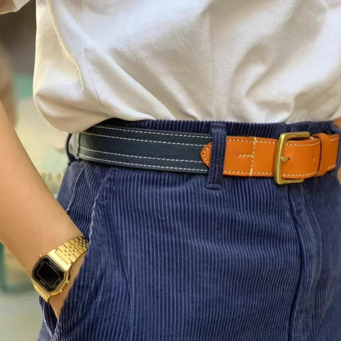 female model pairing white canvas leather belt with denim for a clean summer look