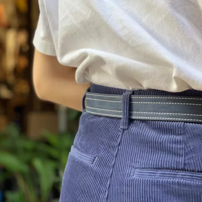 female model pairing white canvas leather belt with denim for a clean summer look