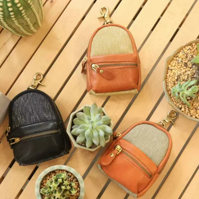Mini Backpack Charm used as a tiny organizer on desk, holding coins, lipstick, and small items