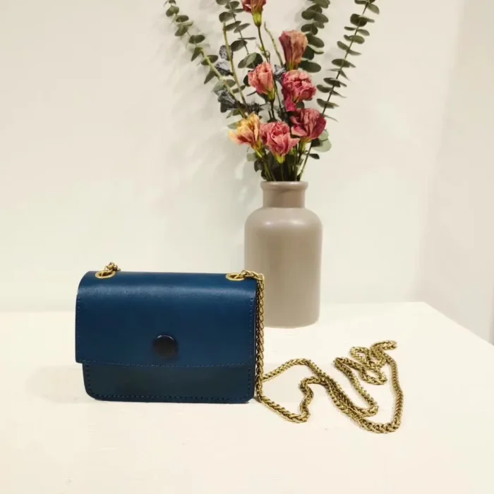 Vegetable-Tanned Leather Mini Crossbody Bag in Aqua Blue, a unique and distinctive shade for an individual style statement.