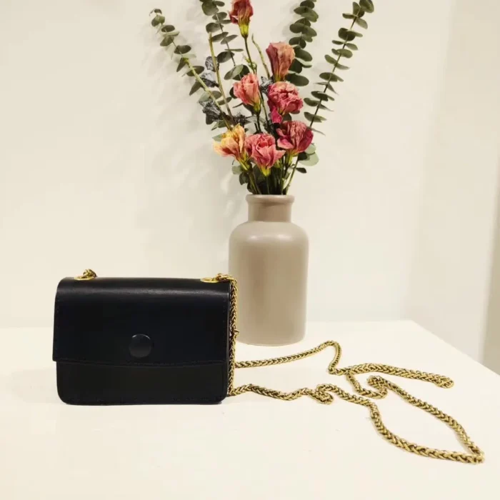Vegetable-Tanned Leather Mini Crossbody Bag in Classic Black, the essential, refined choice for powerful elegance.