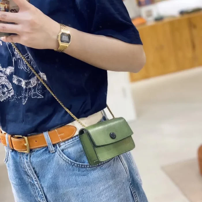 Model wearing the Matcha Green mini crossbody, styled to complement an earthy and refined daily look.