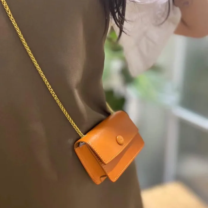 Model wearing the Sunset Yellow mini pouch crossbody, demonstrating its perfect size as a bold accessory.
