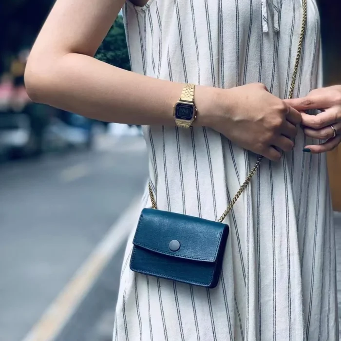 Model showcasing the Aqua Blue mini crossbody, highlighting its appeal as a niche, cool-toned accessory.