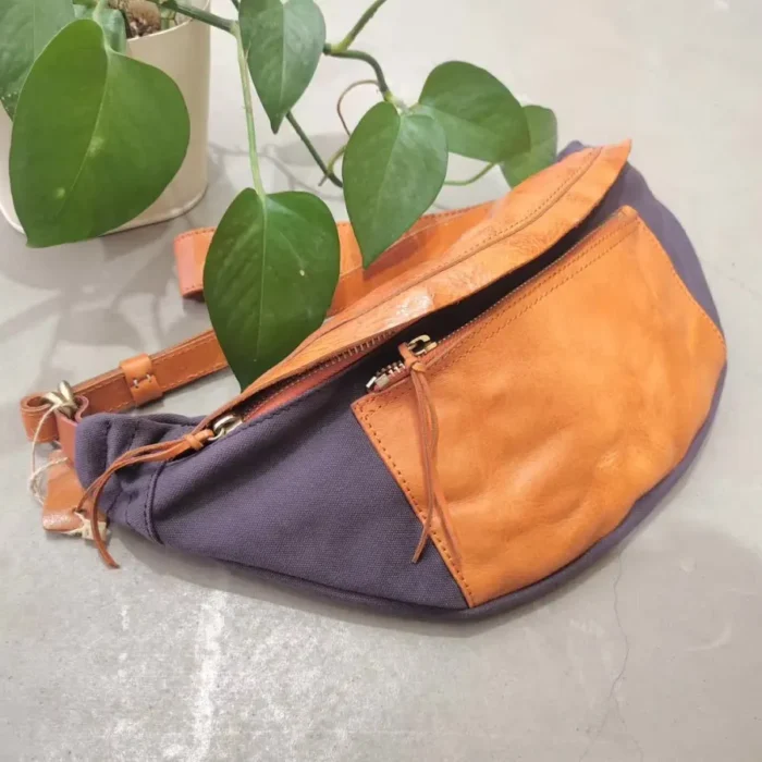 Military Green Canvas Leather Sling Bag, capturing its retro outdoorsy vibe.