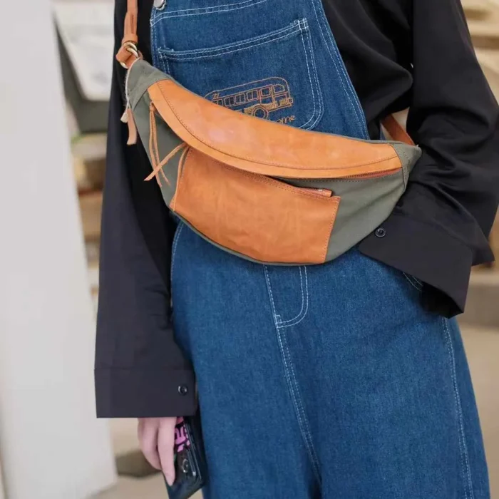 Woman wearing Deep Gray Canvas Leather Sling Bag as a trendy chest bag.