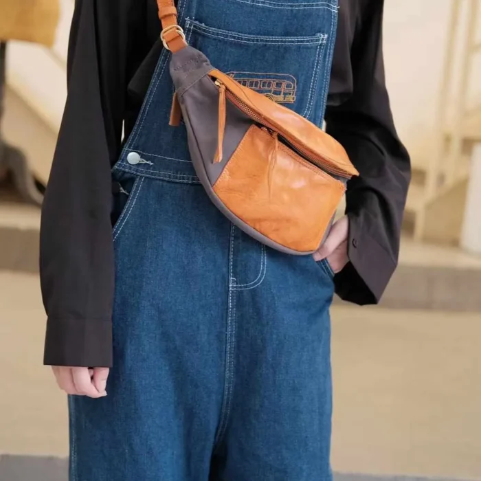Woman wearing Deep Gray Canvas Leather Sling Bag as a trendy chest bag.