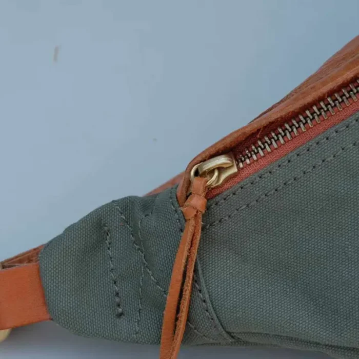 Metal zipper with leather pull on Canvas Leather Sling Bag, exquisite detail.