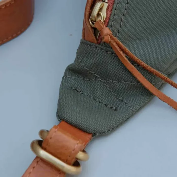 Metal zipper with leather pull on Canvas Leather Sling Bag, exquisite detail.