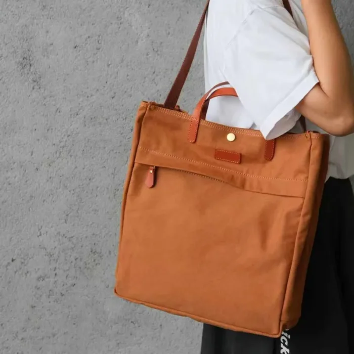Close-up on model carrying the Canvas Tote Bag showing comfortable fit
