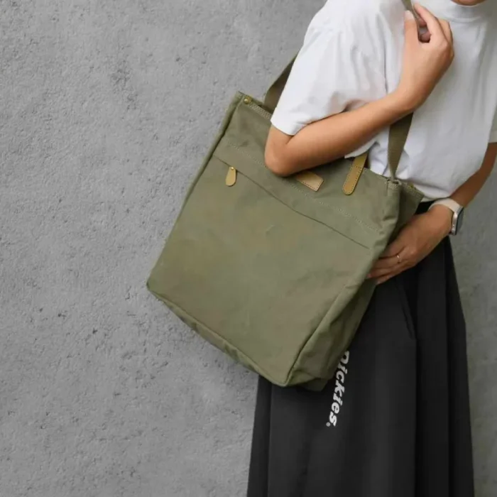 Close-up on model carrying the Canvas Tote Bag showing comfortable fit