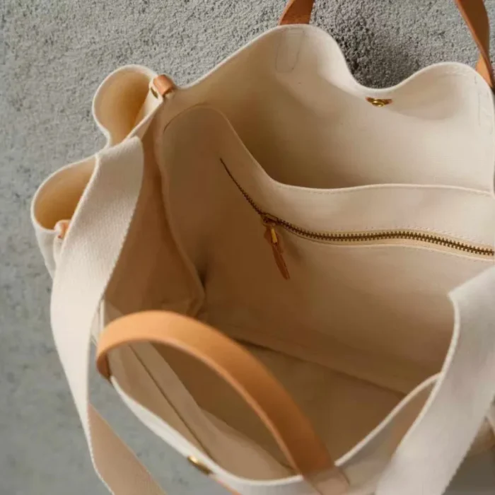 Organized interior of the tote bag showing the 14-inch laptop sleeve