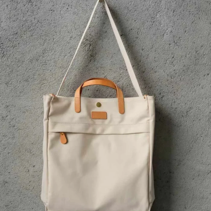 Adjustable and durable shoulder strap detail on the canvas bag