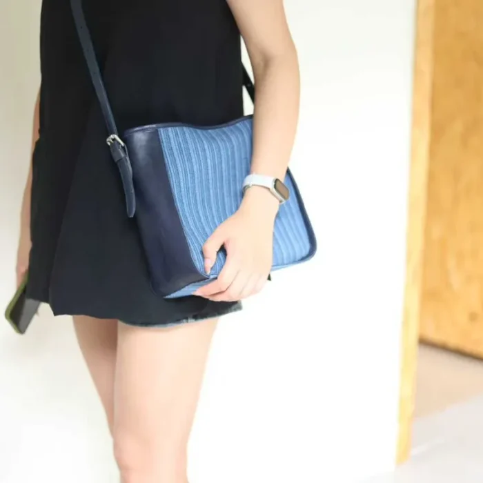 Woman wearing the Striped Denim Leather Crossbody Bag, styled for a hands-free, casual urban look.