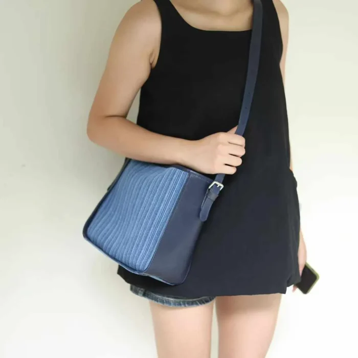Woman wearing the Striped Denim Leather Crossbody Bag, styled for a hands-free, casual urban look.