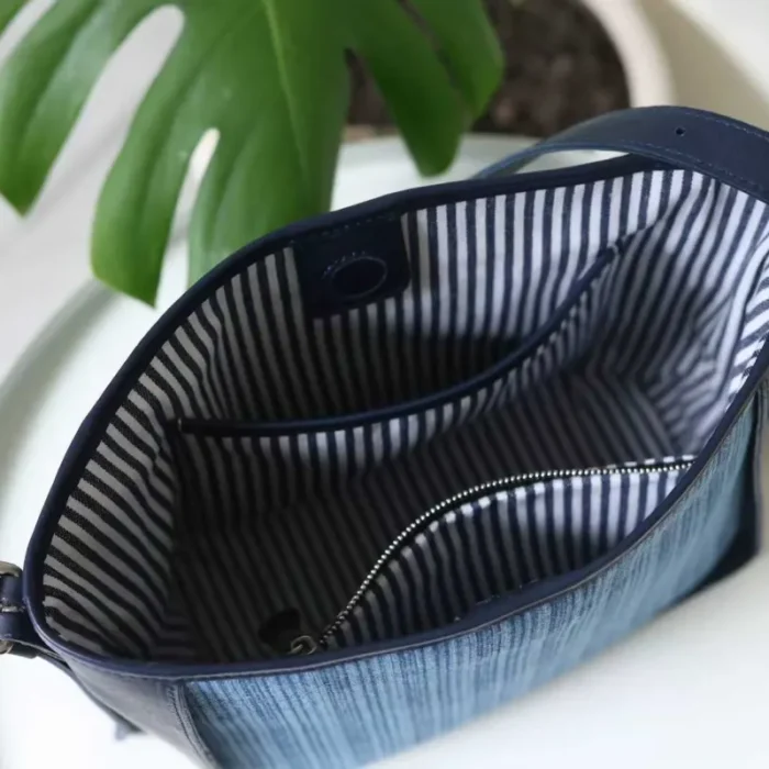 Detailed view of the spacious interior of the Striped Denim Leather Shoulder Bag, showing capacity and lining.