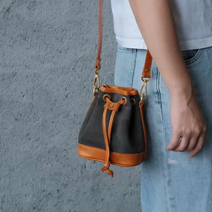 Deep Grey Canvas Leather Mini Bucket Bag on display, emphasizing the sophisticated, versatile shade and quality construction of the vintage crossbody bag.