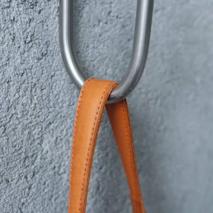 Close-up of the leather top handle on the Mini Bucket Bag, showing the classic hand-carry look.