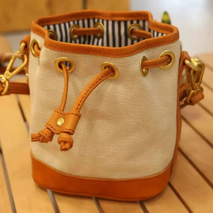 Top view of the drawstring closure on the Bucket Bag, keeping items secure and adding a vintage detail.