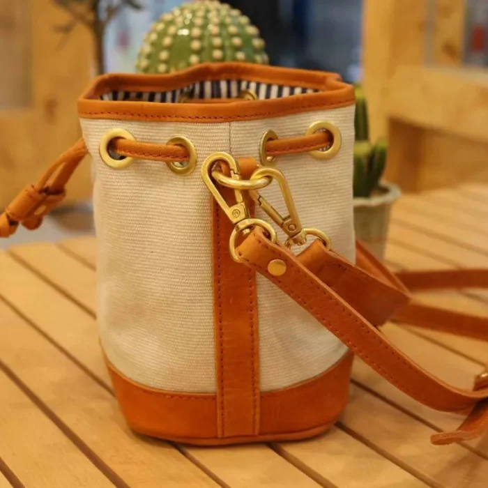 Top view of the drawstring closure on the Bucket Bag, keeping items secure and adding a vintage detail.
