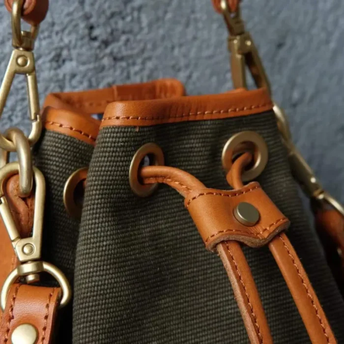 Detailed view of the contrast between the stripe-woven canvas and the patina of the oil waxed leather.