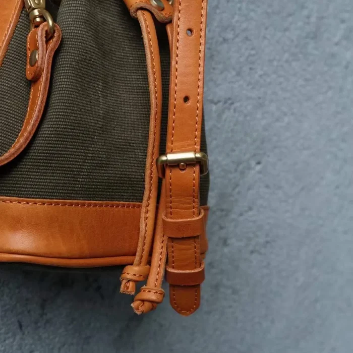 Detailed view of the contrast between the stripe-woven canvas and the patina of the oil waxed leather.