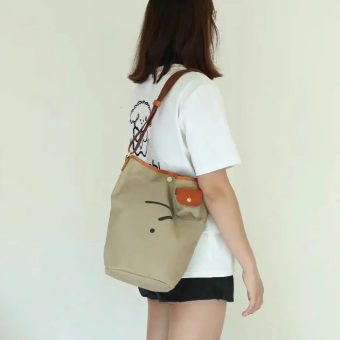 Man or Woman wearing the Navy Blue Bucket Bag on the shoulder, showing the relaxed fit and large capacity.