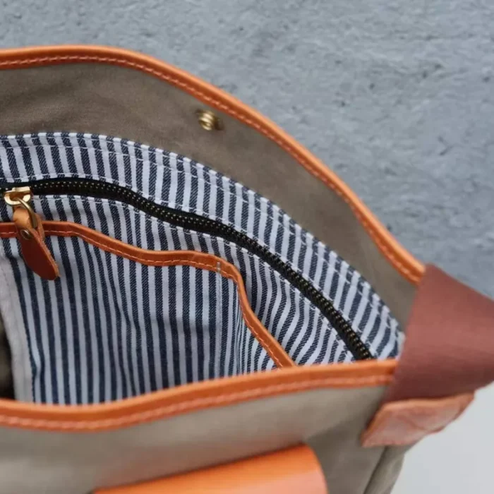 Interior view of the Leather Canvas Unisex Bucket Bag, showing spacious lining and internal organization pockets.