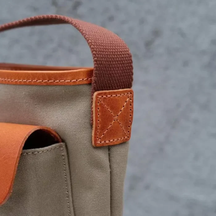 Detailed close-up of the contrast between the 16oz canvas and the rich Oil Waxed Leather trim.