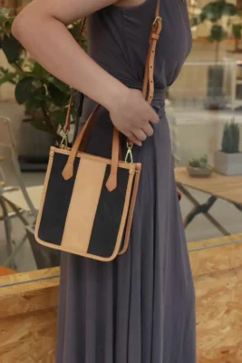 Model wearing the Vegetable Tanned Leather Canvas Mini Tote as a comfortable shoulder bag for daily errands.