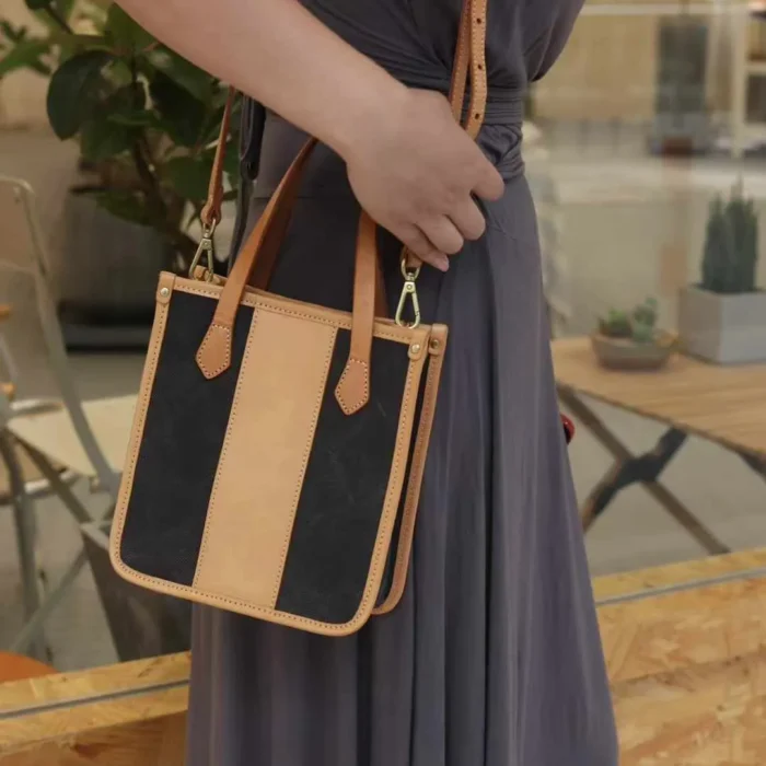 Model wearing the Vegetable Tanned Leather Canvas Mini Tote as a comfortable shoulder bag for daily errands.