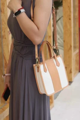 Model wearing the Vegetable Tanned Leather Canvas Mini Tote as a comfortable shoulder bag for daily errands.