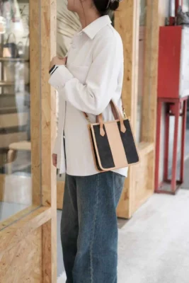 Model wearing the Canvas Mini Tote hands-free as a crossbody bag, perfect for travel or shopping.