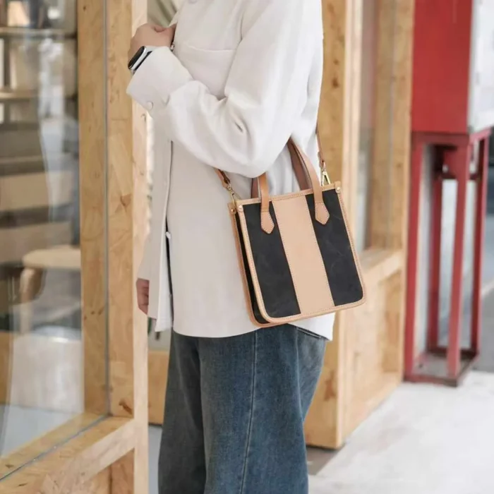 Model wearing the Canvas Mini Tote hands-free as a crossbody bag, perfect for travel or shopping.