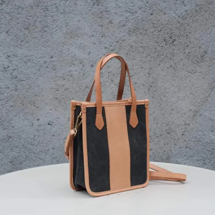 Classic Black Handmade Leather Canvas Bag, showcasing the sharp contrast of black canvas and veg-tanned leather.